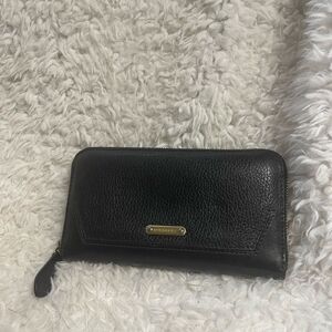 Burberry Leather black zip around wallet gold tone hardwares.